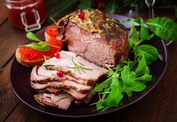 Christmas baked ham and red caviar, served on the old wooden table.