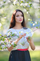 portrait pretty woman at the spring garden wearing stylish jewel