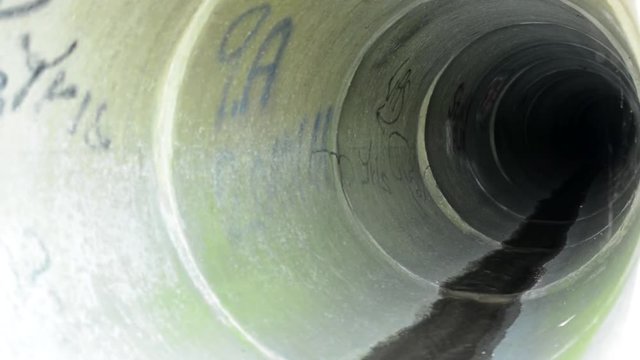 Water trickles down a sewer tunnel