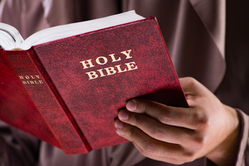 Monk in religious concept on gray background