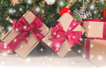 Brown gift box and chirstmas tree on wooden background