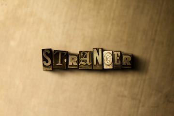 STRANGER - close-up of grungy vintage typeset word on metal backdrop. Royalty free stock - 3D rendered stock image.  Can be used for online banner ads and direct mail.