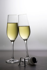 two champagne glasses against a gray background, concept for new year party, vertical