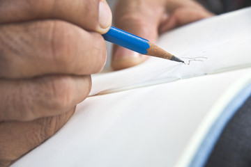 man writing a tree on sketchbook,Environment Conservative concept