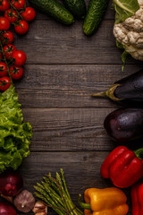 Fresh vegetables for cooking on dark wooden background.