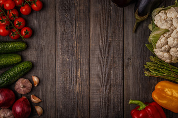 Fototapeta na wymiar Fresh vegetables for cooking on dark wooden background.