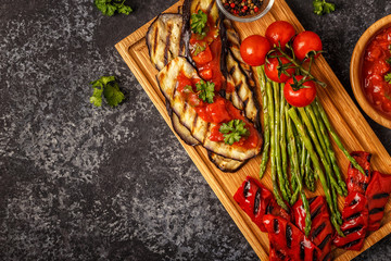 Grilled vegetables with tomato sauce and fresh herbs.