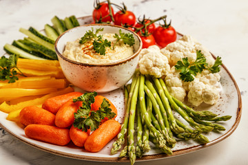 Healthy homemade hummus with assorted fresh vegetables.