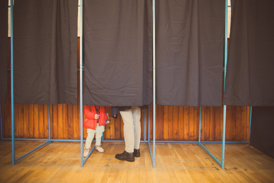 People vote in voting booth