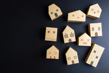 Home architectural model paper box cubes on black background wit