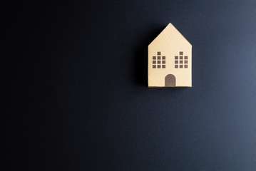 Home architectural model paper box cubes on black background wit