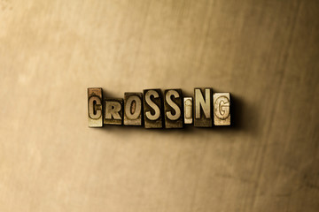 CROSSING - close-up of grungy vintage typeset word on metal backdrop. Royalty free stock - 3D rendered stock image.  Can be used for online banner ads and direct mail.