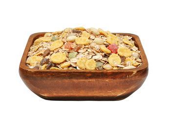 Muesli in wooden bowl isolated on white background