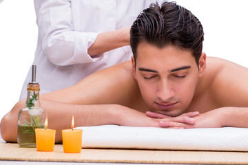 Obraz na płótnie Canvas Handsome man during spa massaging session