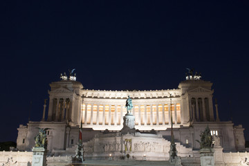 Night view of Altar of the Fatherland captured from Piazza Venezia in Rome. Grand marble, classical...
