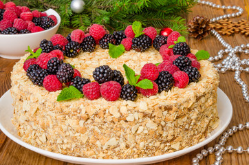Festive Napoleon cake with chocolate custard and berries on top for Christmas and New Year