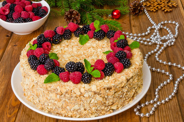 Festive Napoleon cake with chocolate custard and berries on top for Christmas and New Year