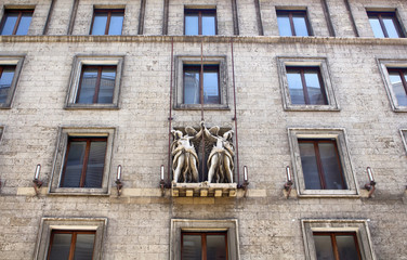 Bottom view of old, historical building in Berlin. Statues are in the view.
