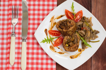 Meatloaf stuffed with mushrooms  sauce and berries. Wooden rustic background. Top view. Close-up