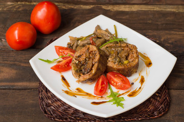 Meatloaf stuffed with mushrooms  sauce and berries. Wooden rustic background. Close-up