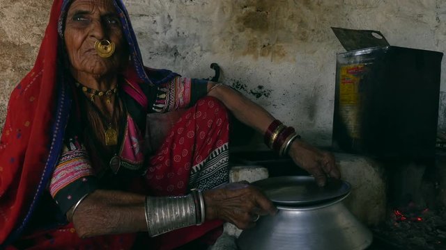 Old Indian Woman Preparing Milk in Jodhpur, India