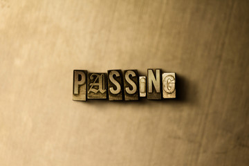 PASSING - close-up of grungy vintage typeset word on metal backdrop. Royalty free stock - 3D rendered stock image.  Can be used for online banner ads and direct mail.