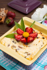 Curd pudding with raisins and strawberry. Wooden rustic table. Close-up. Top view
