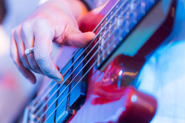 Hands of a musician playing an electric guitar.