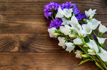 Wild flowers on a wooden background. Top view