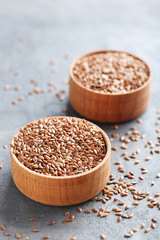 Brown flax seeds on grey wooden table