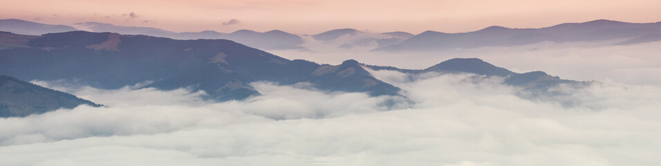 Mountain panorama during sundown. Beautiful natural panoramic landscape in the summer time..