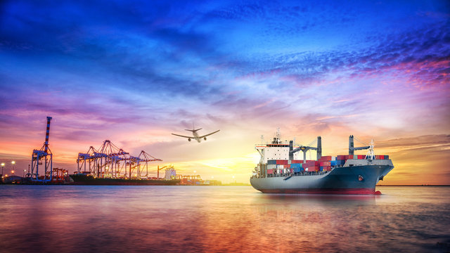 Logistics and transportation of international container cargo ship and cargo plane with ports crane bridge in harbor at twilight sky for logistics import export background and transport industry.
