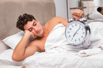 Man having trouble waking up in the morning