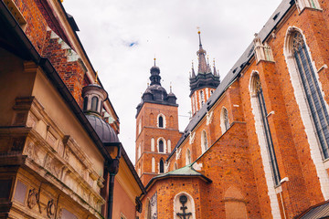 Church of St. Mary in the main Market Square on the background of dramatic sky. Basilica Mariacka. Krakow. Poland.