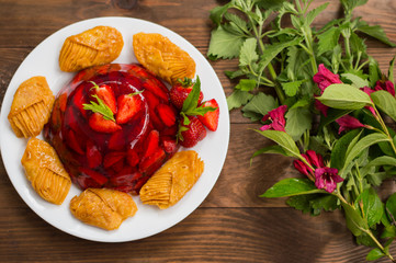 Jelly with strawberries. On a wooden rustic background. Close-up