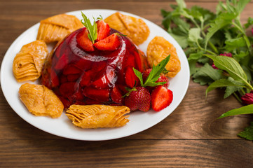 Jelly with strawberries. On a wooden rustic background. Close-up