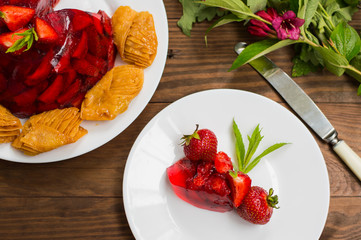 Jelly with strawberries. On a wooden rustic background. Close-up