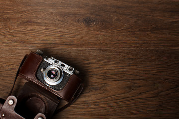 Retro camera on wooden background