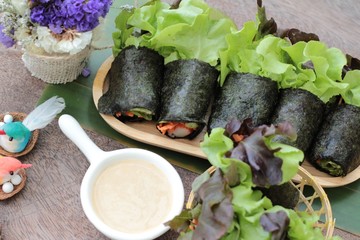 Fresh vegetable salad roll with seaweed and dressing.