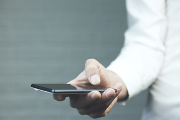 Male hand holding blank mobile smart phone