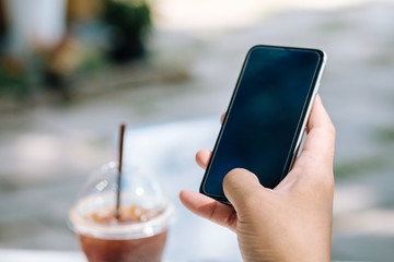 A male(man) hand hold(touch) and looking at smart phone  in the