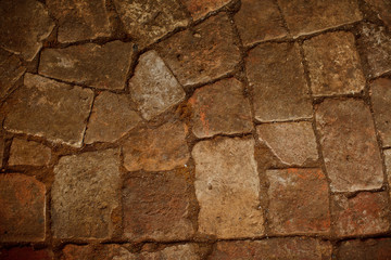 Abstract background of old cobblestone pavement close-up
