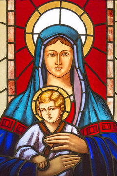 Stained glass window with stained glass depicting the Virgin Mary and baby Jesus