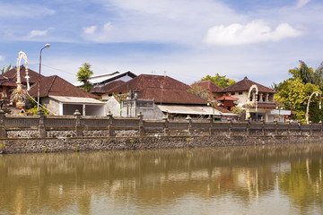 Fototapeta na wymiar Typical Southasian city in Bali by the river 