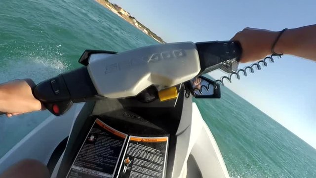 Young guy cruising on a jet ski on the sea