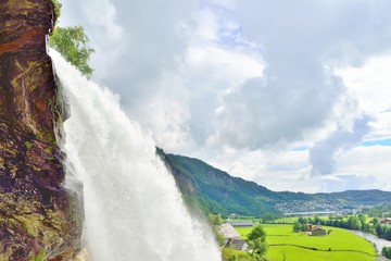 Fototapeta premium Steinsdalsfossen waterfall closeup and Norwegian countryside