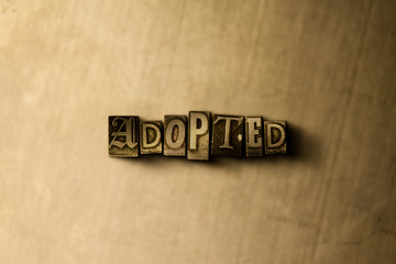 ADOPTED - close-up of grungy vintage typeset word on metal backdrop. Royalty free stock - 3D rendered stock image.  Can be used for online banner ads and direct mail.