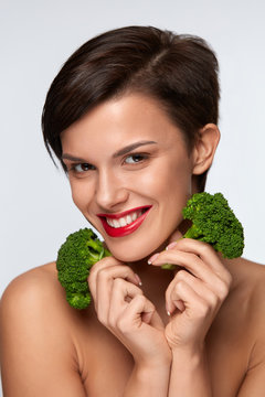 Diet. Beautiful Smiling Woman Holding Organic Green Broccoli