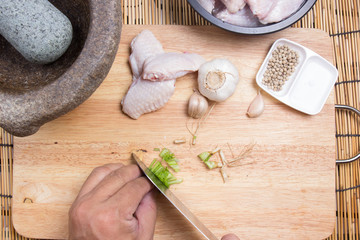 Chef cutting coriander with knife