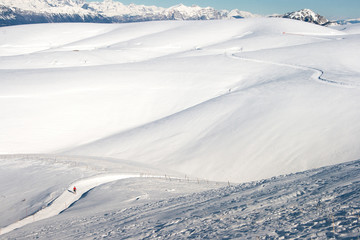 Cross country skier in a snowy mountain panorama